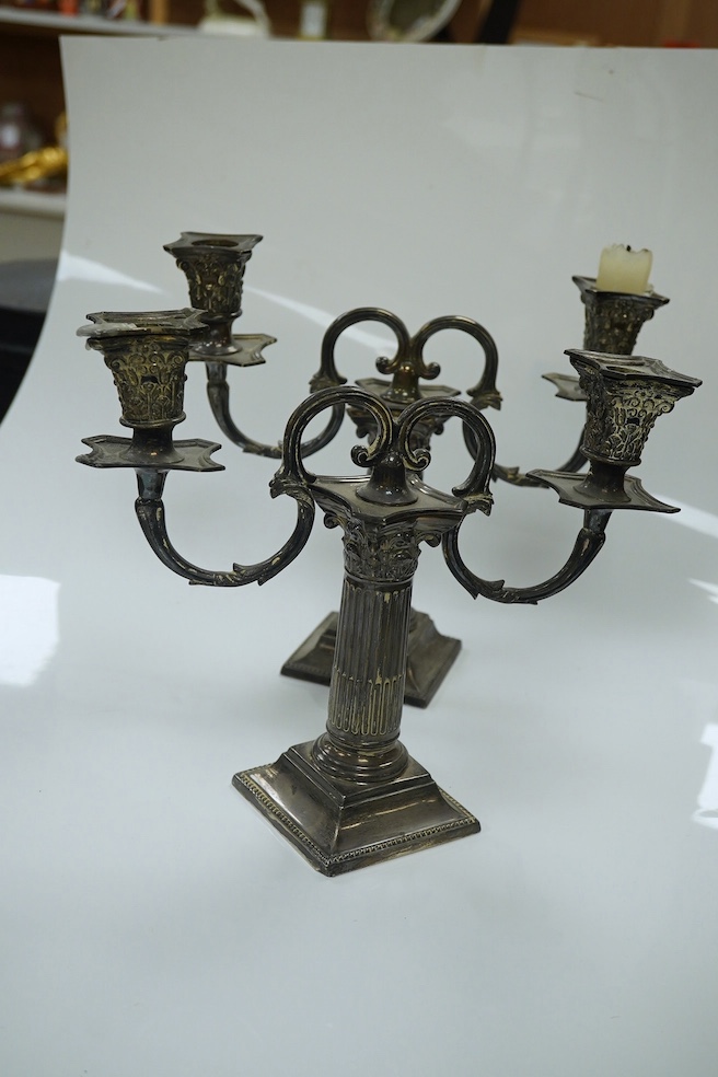 A pair of late Victorian Corinthian column dwarf candlesticks, by Martin, Hall & Co, London, 1894, 14.7cm, weighted, together with a pair of associated silver plated candelabra arms. Condition - poor to fair